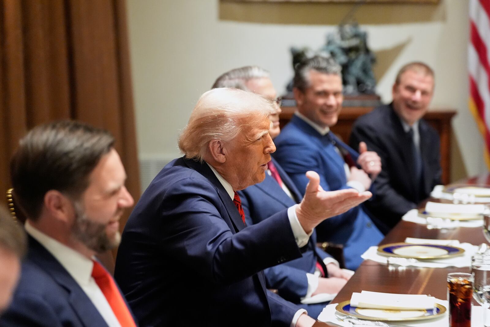 President Donald Trump speaks before a luncheon with Italy's Prime Minister Giorgia Meloni in the Cabinet Room of the White House, Thursday, April 17, 2025, in Washington, as from left, Vice President JD Vance, Treasury Secretary Scott Bessent, Defense and U.S. Ambassador to Italy nominee Tilman Fertitta listen. (AP Photo/Alex Brandon)