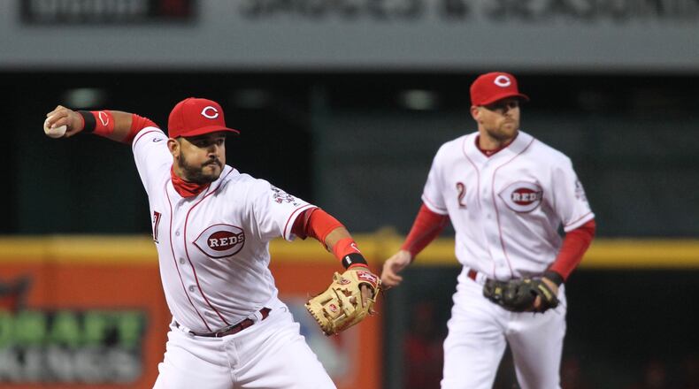 Reds third baseman Eugenio Suarez throws to first for an out against the Pirates on Friday, April 8, 2016, at Great American Ball Park in Cincinnati. David Jablonski/Staff