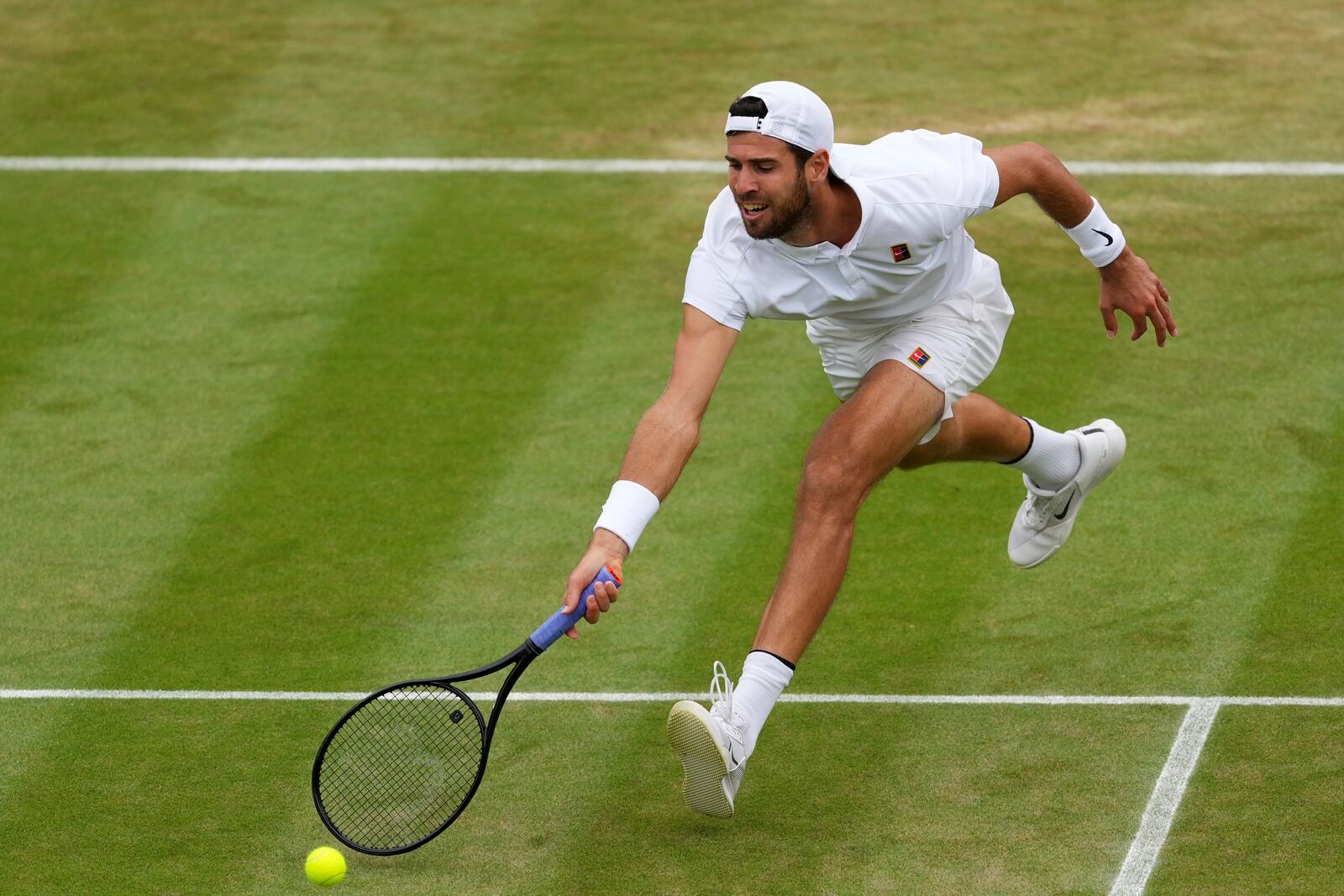 Karen Khachanov of Russia plays a return to Kamil Majchrzak of Poland during their men's singles fourth round match at the Wimbledon Tennis Championships in London, Sunday, July 6, 2025.(AP Photo/Kirsty Wigglesworth)