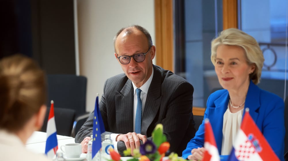 European Commission President Ursula von der Leyen, right, and Germany's Chancellor Friedrich Merz, left, attend a round table meeting on migration at the EU Summit in Brussels, Thursday, Dec. 18, 2025. (AP Photo/Olivier Hoslet, Pool Photo via AP)