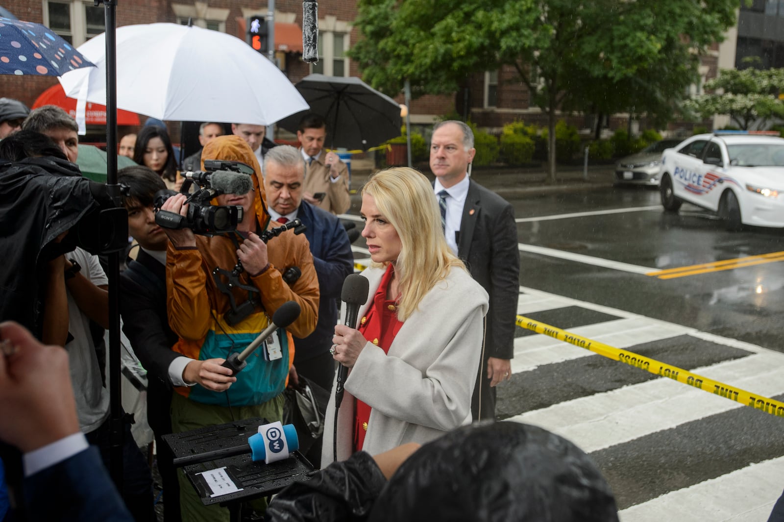 Attorney General Pam Bondi talks with reporters as law enforcement work the scene after two staff members of the Israeli Embassy in Washington were shot and killed outside the Capital Jewish Museum, Thursday, May 22, 2025, in Washington. (AP Photo/Rod Lamkey, Jr.)