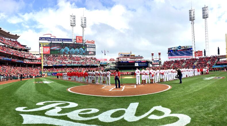 The Reds and Nationals stand for the national anthem on Opening Day on Friday, March 30, 2018, at Great American Ball Park in Cincinnati. David Jablonski/Staff