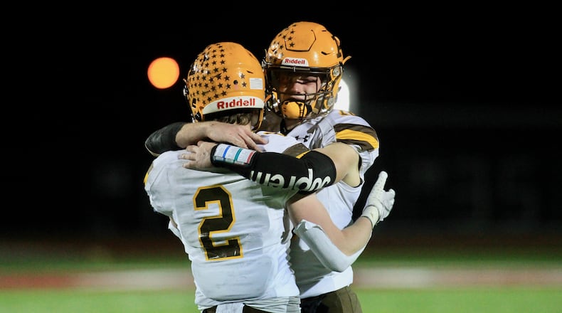 Alter's Aidan Plate, left, and Brian Shane hug after a loss to DeSales in a Division III state semifinal on Friday, Nov. 13, 2020, at London High School. David Jablonski/Staff