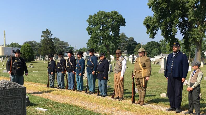 A group of Middletown area Civil War re-enactors of the 12 Ohio Volunteer Infantry render honors at a memorial service of a veteran at the Middletown Pioneer Cemetery. ED RICHTER/STAFF