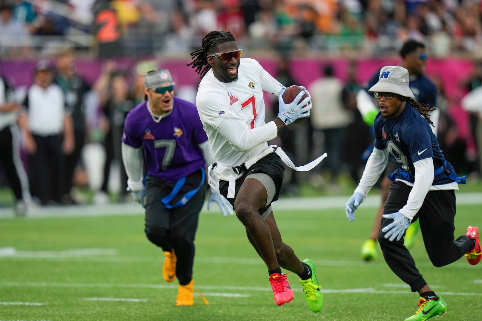 FILE - AFC wide receiver Brian Thomas Jr. (7), of the Jacksonville Jaguars, runs away from NFC return specialist KaVontae Turpin, of the Dallas Cowboys, right, during the flag football event at the NFL Pro Bowl, Sunday, Feb. 2, 2025, in Orlando. (AP Photo/Chris O'Meara, File)