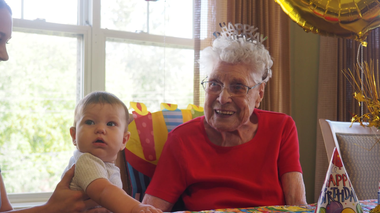 Mary Hummell with Alex, 5 months old, of Hamilton. Her 105th birthday party was baby themed. BRYN DIPPOLD/STAFF
