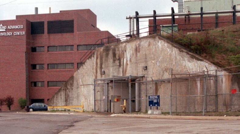 This photograph taken in 1997 shows one of the two entrances to T building on the grounds of Mound Lab in Miamisburg. The building, five stories underground (the newer building on the left is about five stories), is where Monsanto Chemical developed triggering device for the atomic bomb during World War II. This entrance is at the top of the secret installations that was built by carving out the earth on the other side of this hill, building the building and then packing the dirt back around it. FILE PHOTO