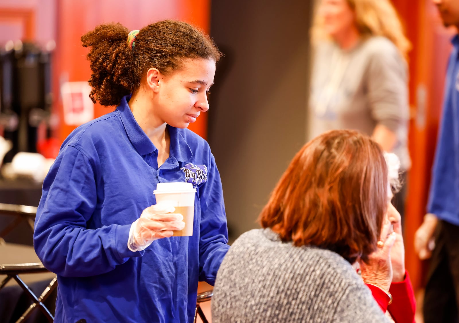 Hamilton High School senior Kaiya Lynch-Fuller helps serve drinks on Wednesday, Dec. 3, 2025, during the Fitton Center for Creative Arts' Celebrating Self lunchtime speaker series in Hamilton. She is with the Hamilton High School Transitions program, which helps students with developmental and intellectual disabilities transition into post-high school life. They partner with local businesses, including the Fitton Center. NICK GRAHAM/STAFF