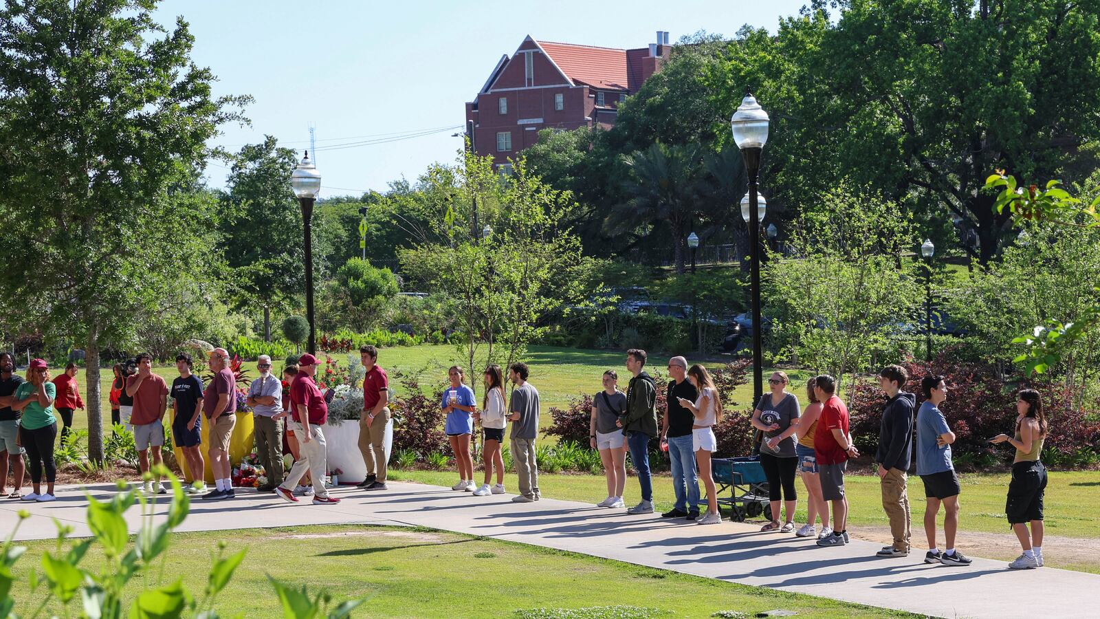 Students wait to retrieve their personal items from the Florida State Student Union building, Tallahassee, Fla., Friday, April 18, 2025. (AP Photo/Gary McCullough)