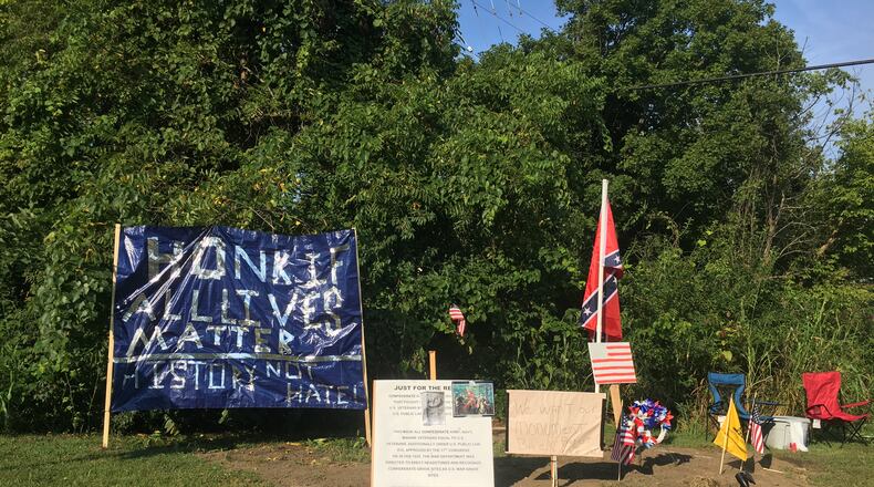 Banners as well as Confederate and American flags have been placed at the former site of a Confederate monument at the corner of Dixie Highway and Hamilton Middletown Road in Franklin. RICK McCRABB/STAFF