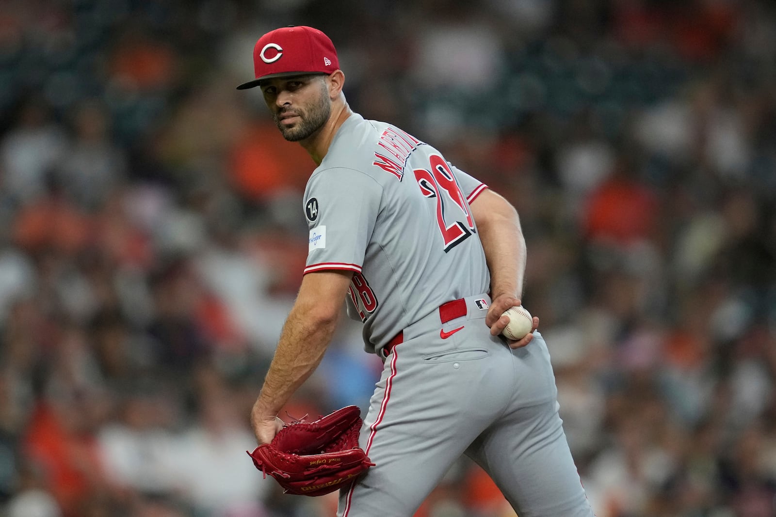 Cincinnati Reds starting pitcher Nick Martinez (28) looks back at first base during the first inning of a baseball game against the Houston Astros in Houston, Friday, May 9, 2025. (AP Photo/Ashley Landis)
