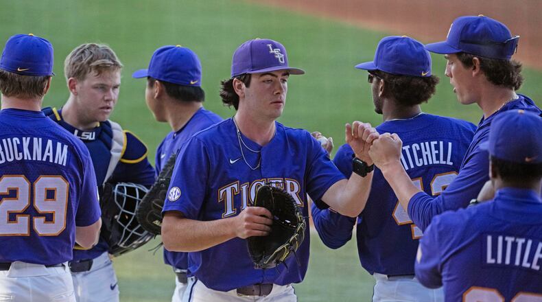 LSU starting pitcher Luke Holman (38) greets his teammates after pitching the first inning against Vanderbilt during an NCAA college baseball game Thursday, April 4, 2024, in Baton Rouge, La. (Hilary Scheinuk/The Advocate via AP)