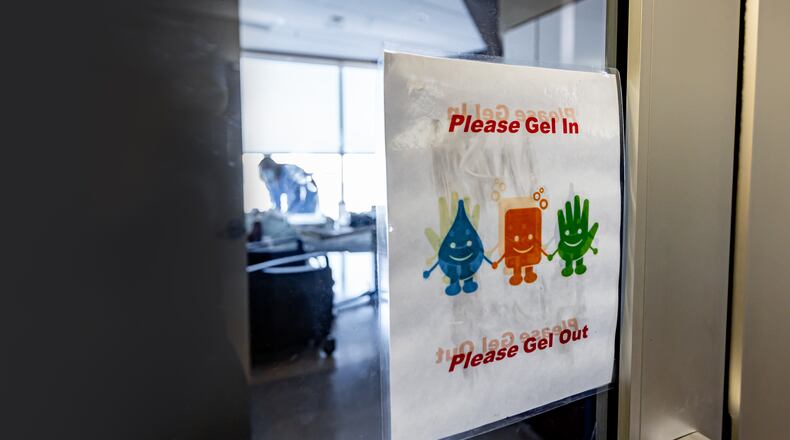 MVH signage on the door as a nurse works with COVID patient in the background, from 2020. CONTRIBUTED BY PREMIER HEALTH