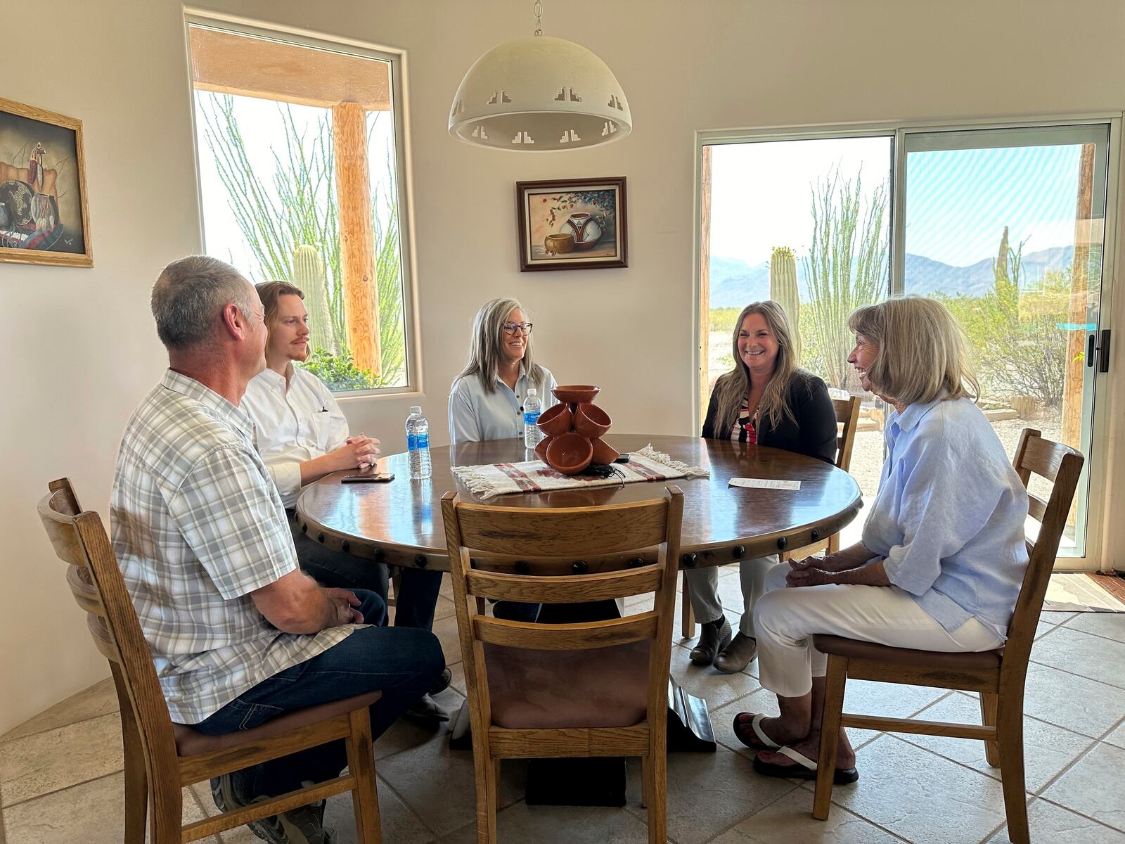 Arizona Gov. Katie Hobbs, center, meets with residents of western Arizona to talk about groundwater during a tour of La Paz County, Ariz., Wednesday, May 28, 2025. (AP Photo/Sejal Govindarao)