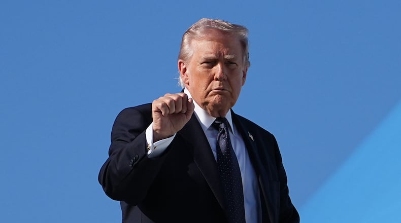 President Donald Trump gestures as he boards Air Force One at Palm Beach International Airport, Sunday, March 1, 2026, in West Palm Beach, Fla. (AP Photo/Matt Rourke)