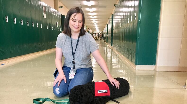 Rudy the therapy dog is the newest addition to the Badin High School and she has already proved both popular and effective, say school officials at the Catholic high school in Hamilton. MICHAEL D. CLARK/STAFF
