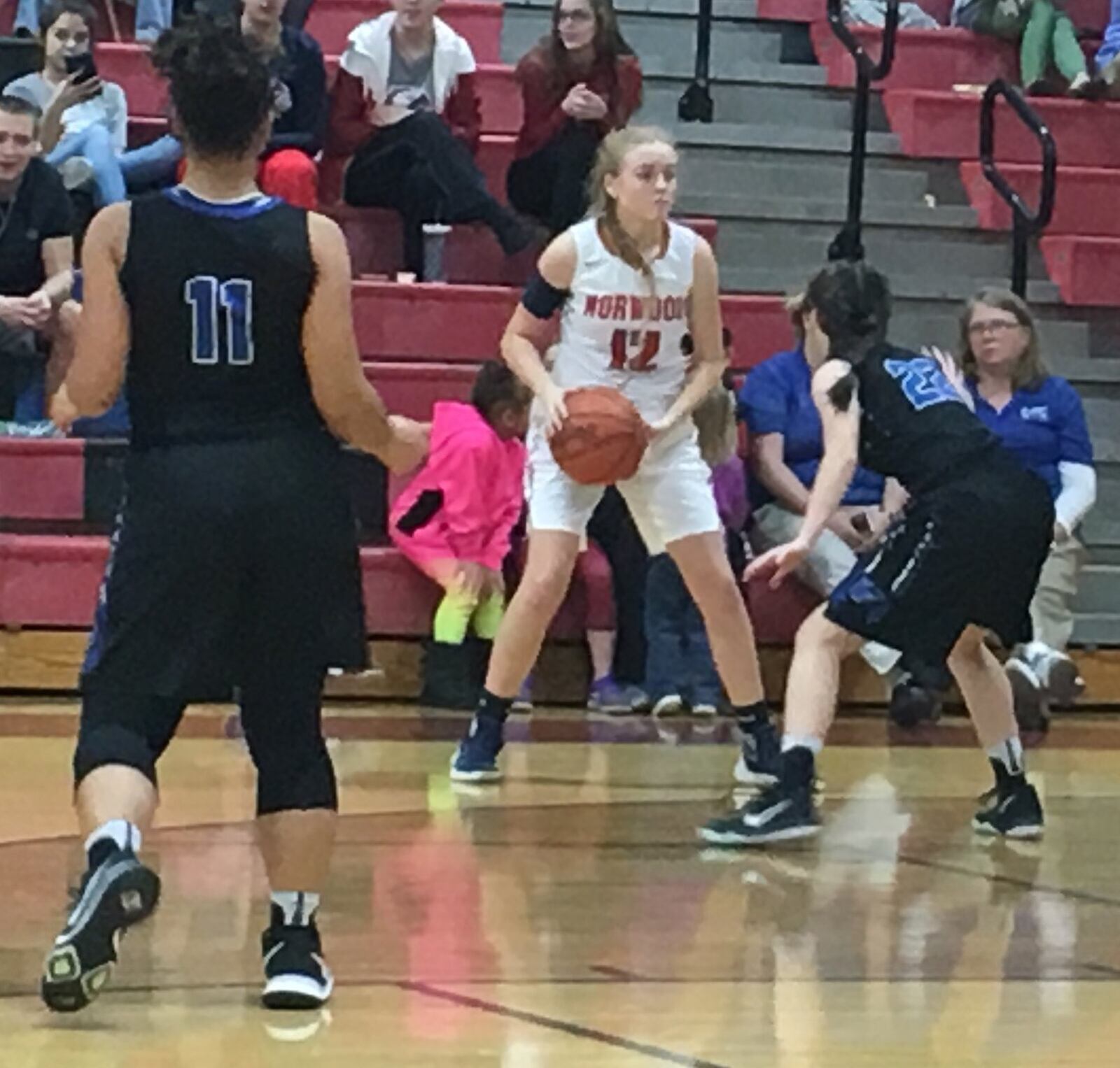 Cincinnati Christian’s Hannah Randall (22) guards Holly Borgemenke (12) of Norwood during Wednesday night’s game at Norwood. That’s Daja Thacker (11) closing in on the play for CCS. RICK CASSANO/STAFF