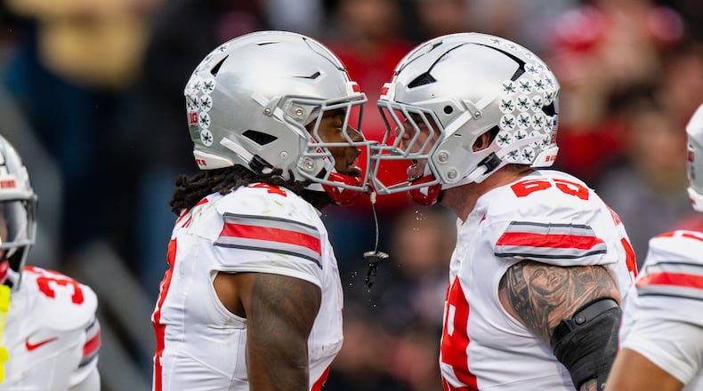 Ohio State wide receiver Jeremiah Smith (4) celebrates a touchdown with offensive lineman Ian Moore (69) during the first half of an NCAA college football game against Purdue, Saturday, Nov. 8, 2025, in West Lafayette, Ind. (AP Photo/Doug McSchooler)