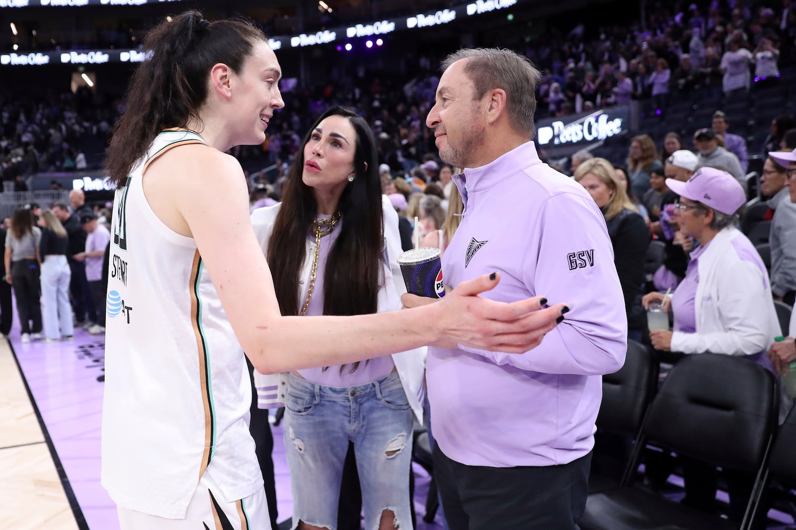 New York Liberty's Breanna Stewart chats with Golden State Valkyries' owner Joe Lacob and his wife Nicole Curran after New York's win in an WNBA basketball game in San Francisco on Wednesday, June 25, 2025. (Scott Strazzante/San Francisco Chronicle via AP)