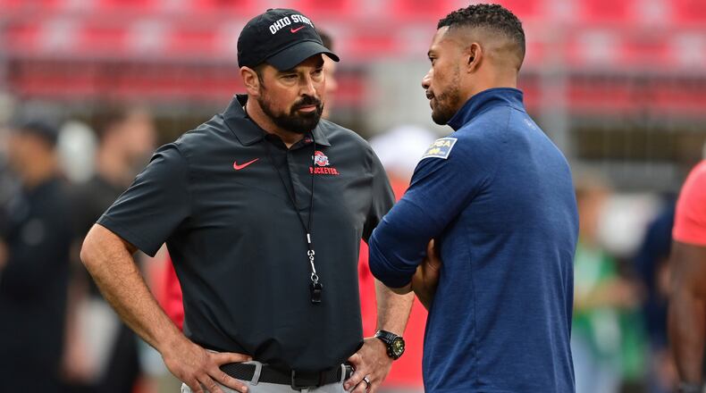 Ohio State head coach Ryan Day, left, and Notre Dame head coach Marcus Freeman talk before an NCAA college football game Saturday, Sept. 3, 2022, in Columbus, Ohio. (AP Photo/David Dermer)