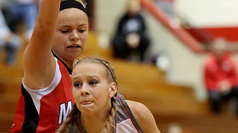 Carlisle guard Christa Harris is covered by Madison’s Kenzi Saunders during their game at Carlisle on Dec. 10, 2016. COX MEDIA FILE PHOTO