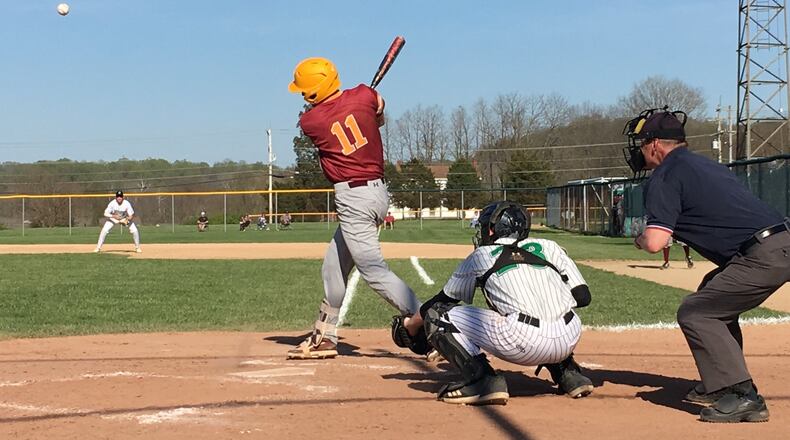 Montana Allgaier (11) of Ross makes contact with the ball as Harrison catcher Micah Childs (23) watches during Tuesday’s game at Harrison. RICK CASSANO/STAFF
