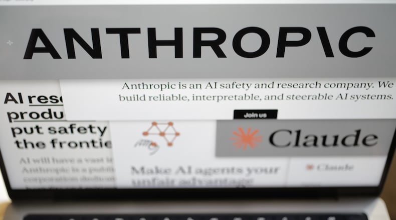 Pages from the Anthropic website and the company's logos are displayed on a computer screen in New York on Thursday, Feb. 26, 2026. (AP Photo/Patrick Sison)