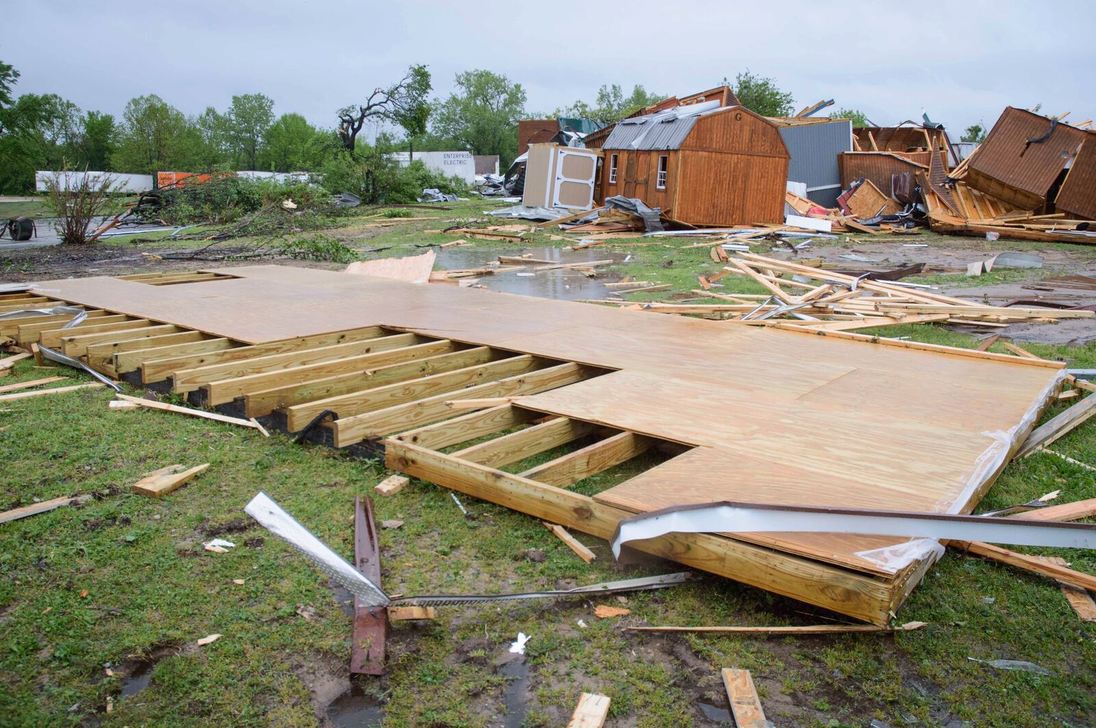 Broken sheds, lumber, and walls lie strewn on the ground behind Quality Inn, Sunday, April 20, 2025 in Ada, Okla. (Richard R. Barron/The Ada News via AP)