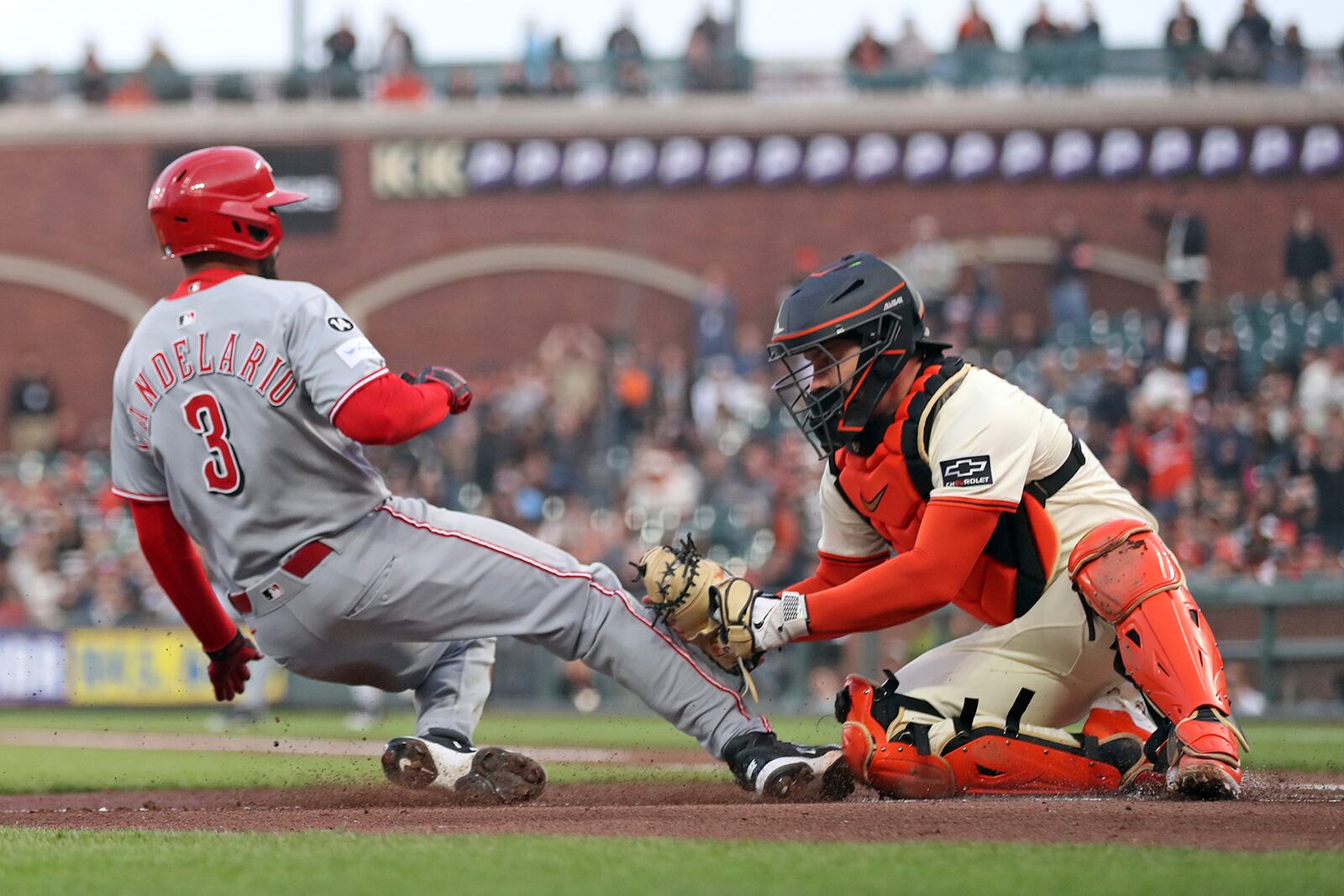 San Francisco Giants' Patrick Bailey tags out Cincinnati Reds' Jeimer Candelario attempting to steal home in the second inning of a baseball game in San Francisco on Monday, April 7, 2025. (Scott Strazzante/San Francisco Chronicle via AP)