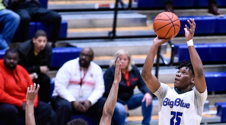 Hamilton’s D’Marco Howard delivers a shot over Princeton’s Micah Thomas during their Feb. 1 game at the Hamilton Athletic Center. Princeton won 44-43. NICK GRAHAM/STAFF