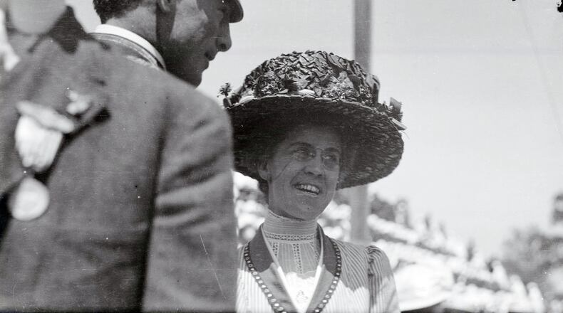 Katharine Wright is with Lt. Frank P. Lahm of the United States Army Signal Corps during the 1909 Wright Brothers Homecoming Celebration medals ceremony held on the morning of Friday, June 18, 1909 at the Montgomery County Fairgrounds. In the grandstands, school children are clothed in red, white, and blue, to form a United States of America flag in the grandstands. ARCHIVE PHOTO