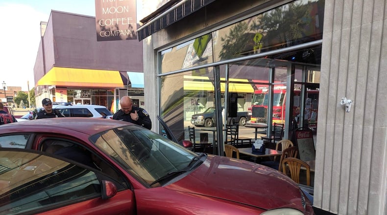 A 2001 Ford Taurus crashed into Triple Moon Coffee Company, 1100 Central Ave., around 6:40 p.m. Sunday after the male driver and female passenger were involved in a domestic violence situation at Hueston Woods State Park. CONTRIBUTED PHOTO