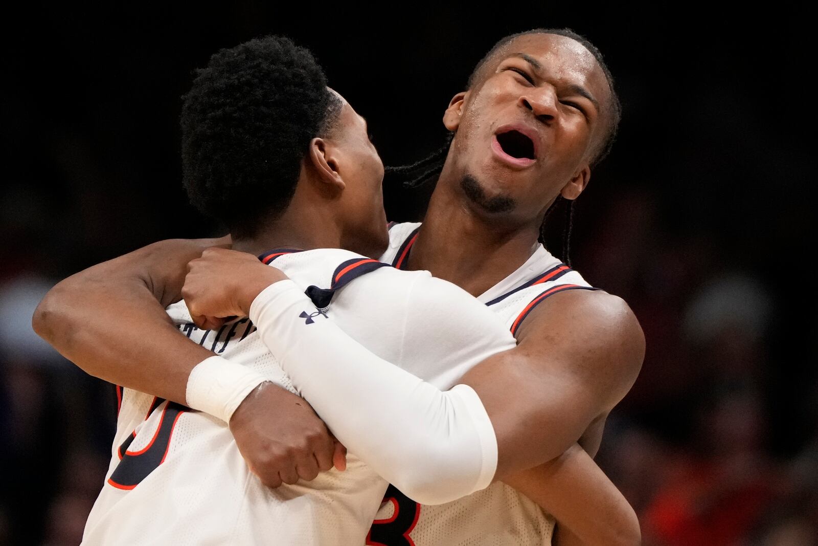 Auburn's Tahaad Pettiford, left, and Miles Kelly (13) celebrate a win over Michigan State after the Elite Eight of the NCAA college basketball tournament, Sunday, March 30, 2025, in Atlanta. (AP Photo/Brynn Anderson)