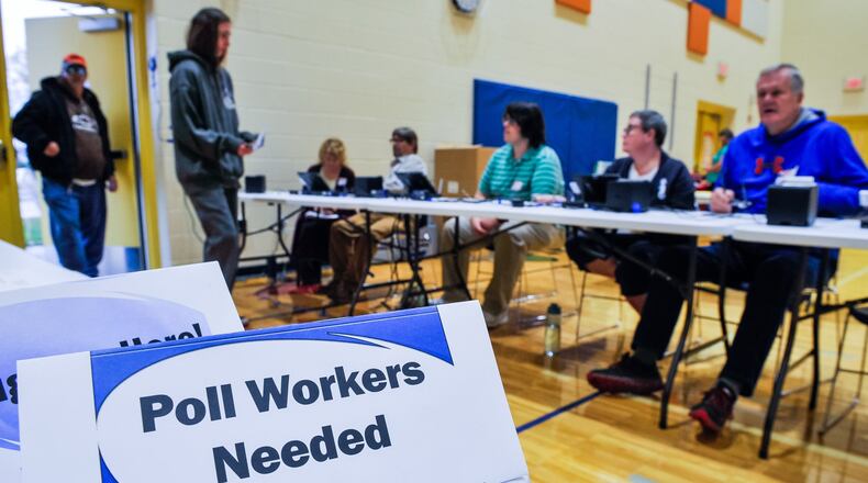 Voters check in with poll workers to cast their ballots on election day Tuesday, Nov. 5, 2019 at Highland Elementary School in Hamilton. NICK GRAHAM/STAFF