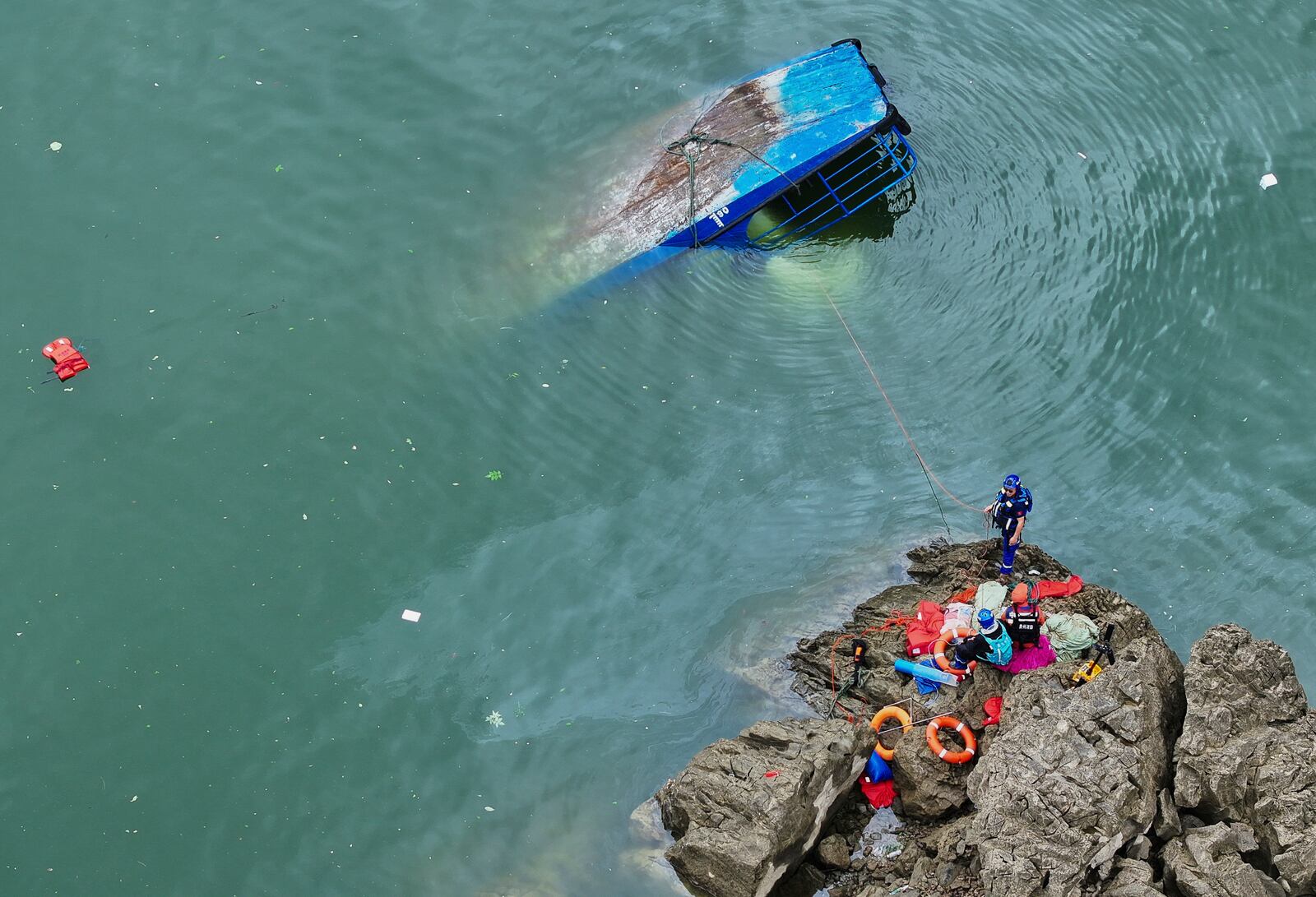 In this photo released by Xinhua News Agency, rescuers conduct a search and rescue operation at one of the two passenger boats capsized in Qianxi City, southwest China's Guizhou Province on Monday, May 5, 2025. (Liu Xu/Xinhua via AP)