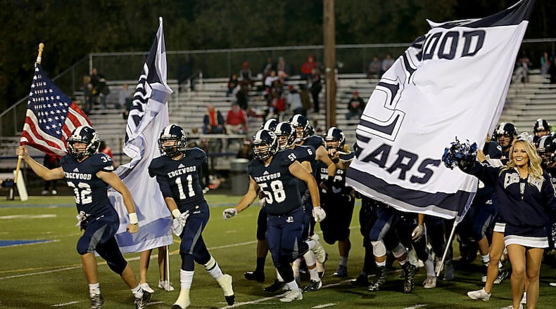 Nate Fryman carries the American flag as the Edgewood Cougars take the field for their game against visiting Mt. Healthy at Kumler Field in Trenton on Oct. 28, 2016. The host Cougars won 49-28. CONTRIBUTED PHOTO BY E.L. HUBBARD