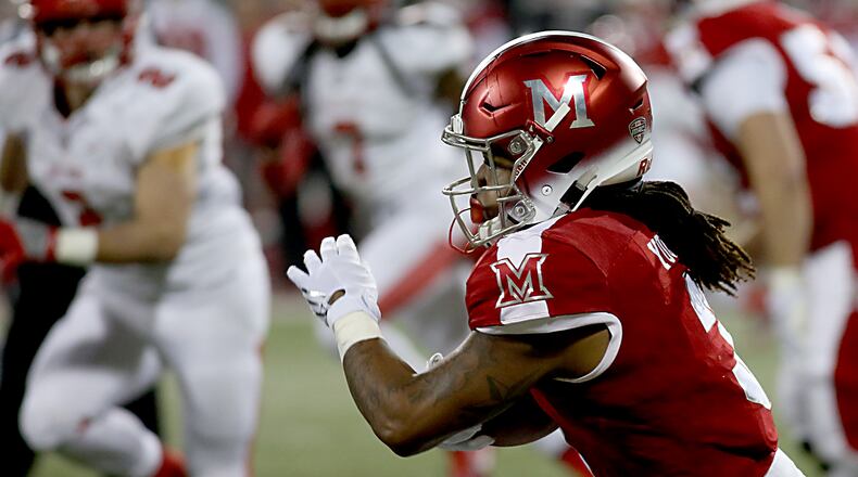 Contributed photo by E.L. Hubbard Miami RedHawk running back Kenny Young carries the ball against Ball State during their MAC contest at Yager Stadium in Oxford Tuesday, Nov. 22, 2016.