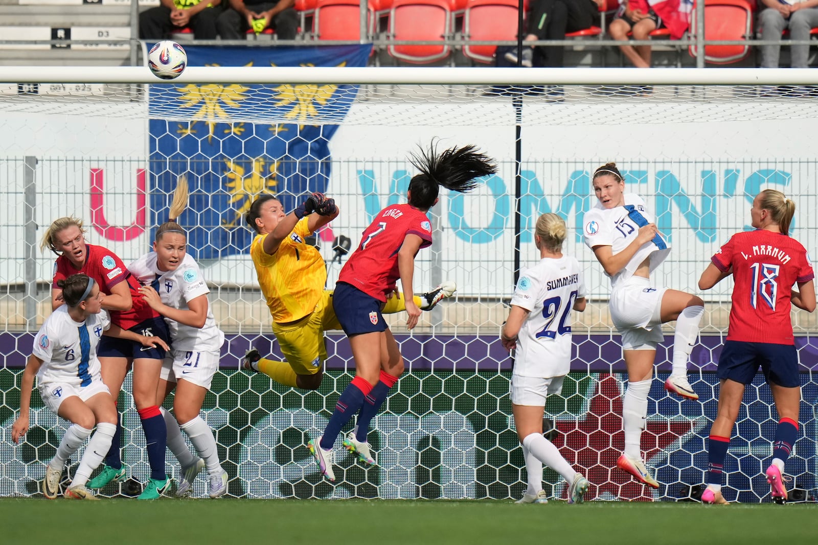 Norway's Ingrid Engen, center, tries to score past Finland goalkeeper Anna Koivunen during the Euro 2025, group A, soccer match between Norway and Finland at Stade de Tourbillon in Sion, Switzerland, Sunday, July 6, 2025. (AP Photo/Alessandra Tarantino)