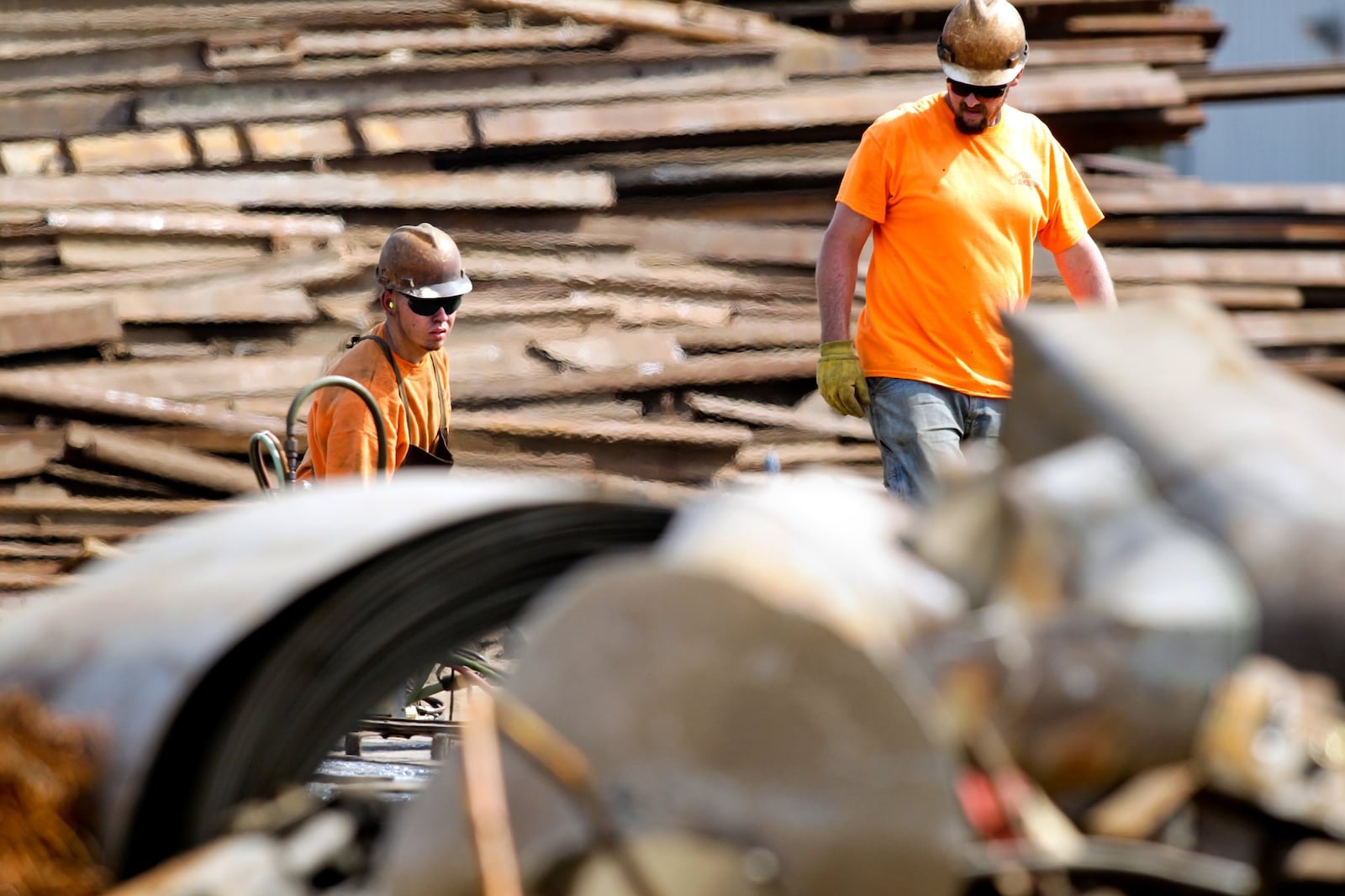 Cohen Recycling employees sort through material at their Middletown facility Thursday, Aug. 18, 2013. NICK DAGGY / STAFF