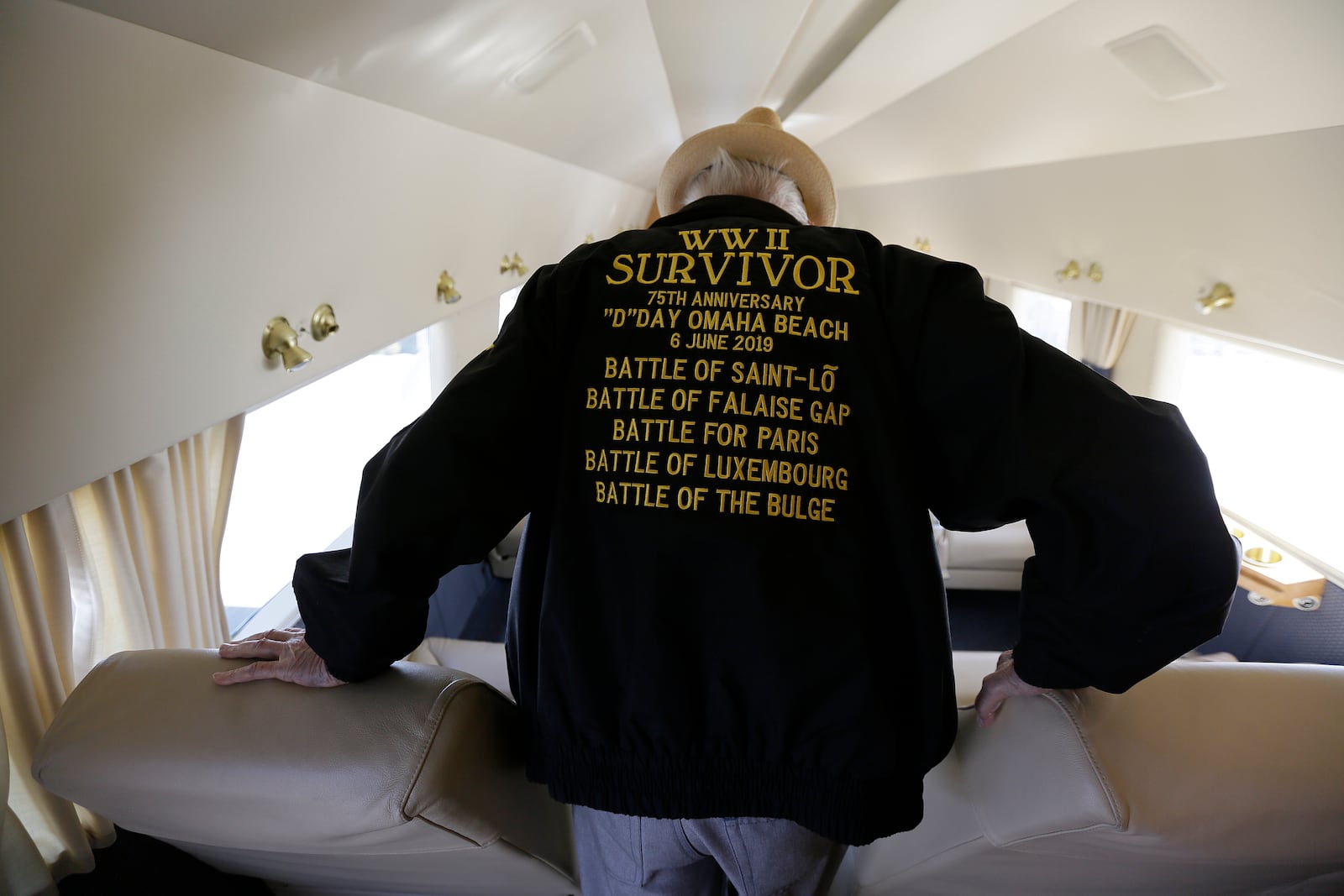 FILE - In this photo taken April 29, 2019, D-Day veteran Jake Larson walks to a seat before going for a ride in the "The Spirit of Benovia" WWII-era aircraft in Oakland, Calif. Both Larson and the former C-53 Skytrooper transport plane plan to be in Normandy, France and take part in events for the 75th anniversary of D-Day. (AP Photo/Eric Risberg, file)