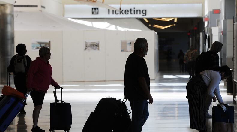 Travelers were making their way through the Dayton International Airport Thursday, Oct. 20, 2022. Prices at area airports have risen over the last year, according to federal data, and experts say that people who plan to travel during the upcoming holidays should buy their tickets as soon as possible. MARSHALL GORBY\STAFF