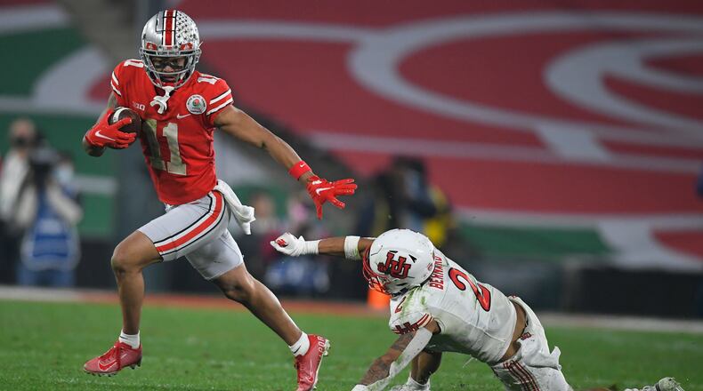 Ohio State wide receiver Jaxon Smith-Njigba (11) runs past Utah cornerback Kenzel Lawler (2) during the second half in the Rose Bowl NCAA college football game Saturday, Jan. 1, 2022, in Pasadena, Calif. (AP Photo/John McCoy)