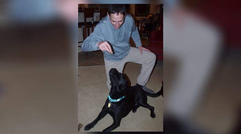Teddy waiting for Ed to give him a food treat after executing a positive behavior. KARIN SPICER/CONTRIBUTED