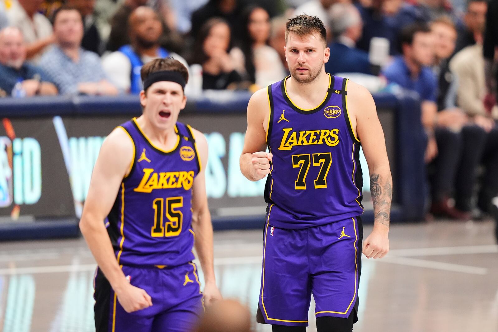 Los Angeles Lakers' Austin Reaves (15) and Luka Doncic (77) celebrate in the second half of an NBA basketball game against the Dallas Mavericks in Dallas, Wednesday, April 9, 2025. (AP Photo/LM Otero)