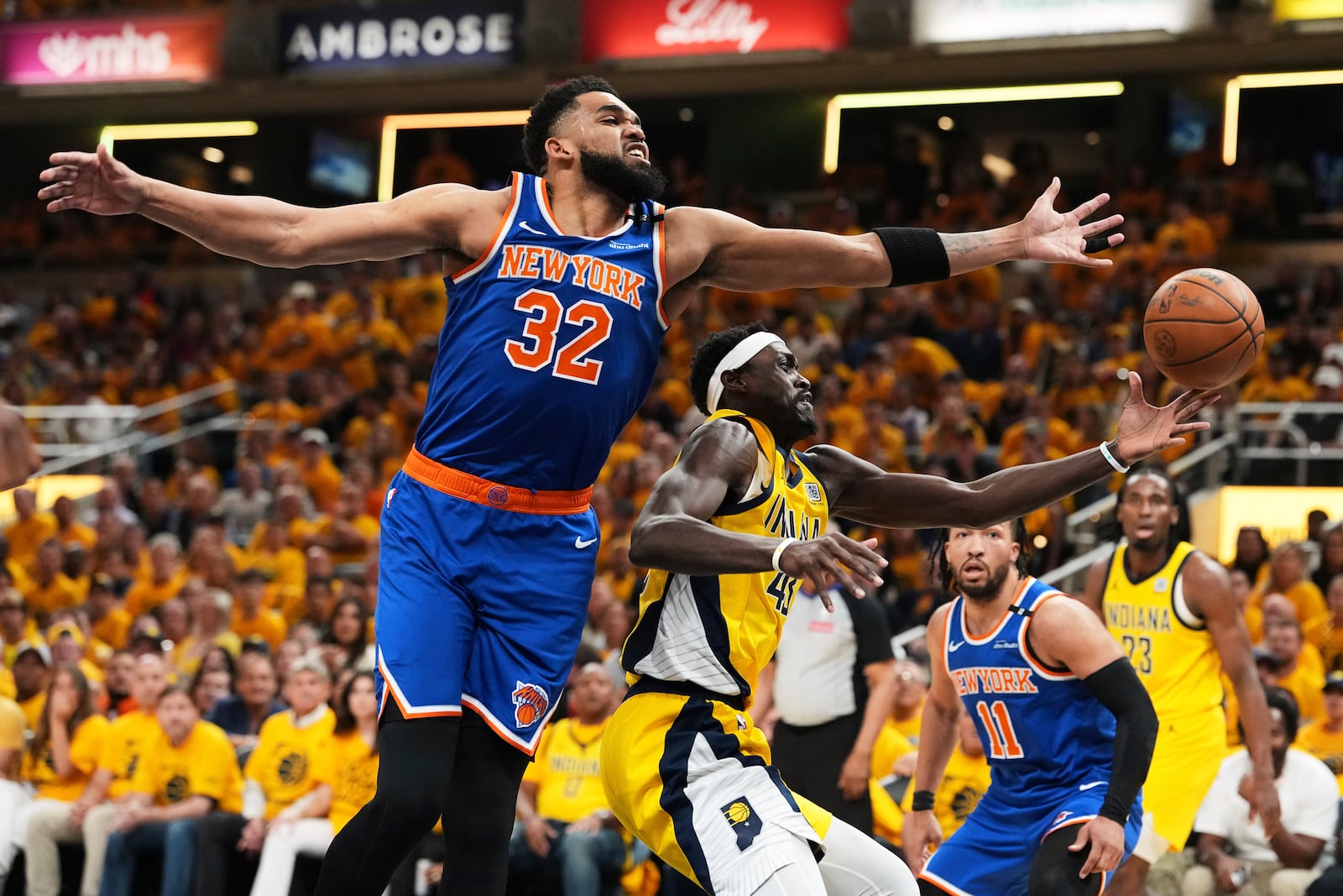 New York Knicks center Karl-Anthony Towns (32) and Indiana Pacers forward Pascal Siakam (43) reach for the ball during the first half of Game 6 of the Eastern Conference finals of the NBA basketball playoffs in Indianapolis, Saturday, May 31, 2025. (AP Photo/Michael Conroy)