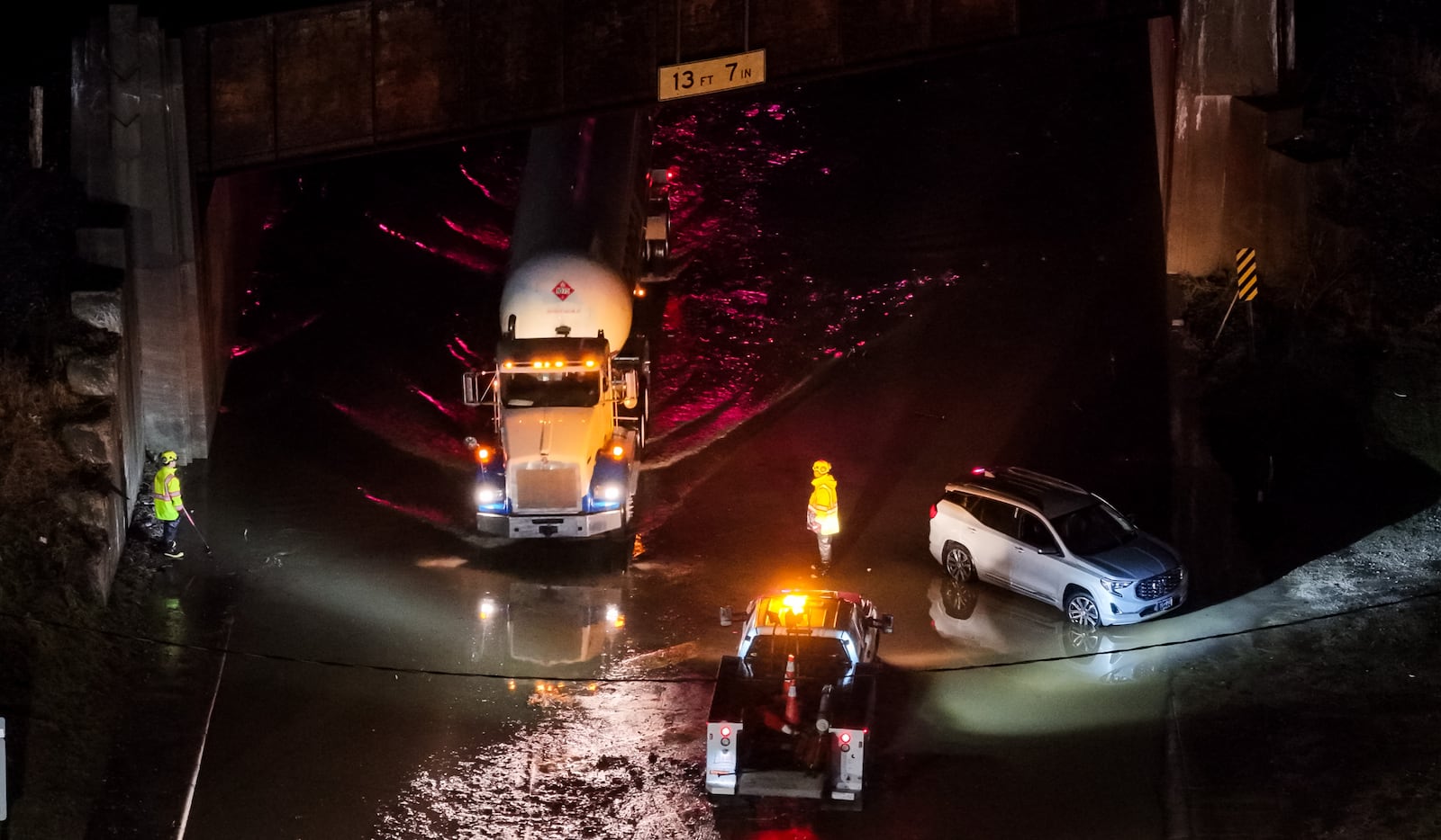A crew from Ohio Department of Transportation works to clear drains on a flooded Germantown Road early Thursday morning, March 5, 2026 in Madison Township in Butler County. Heavy rain caused flooding in many areas. NICK GRAHAM/STAFF