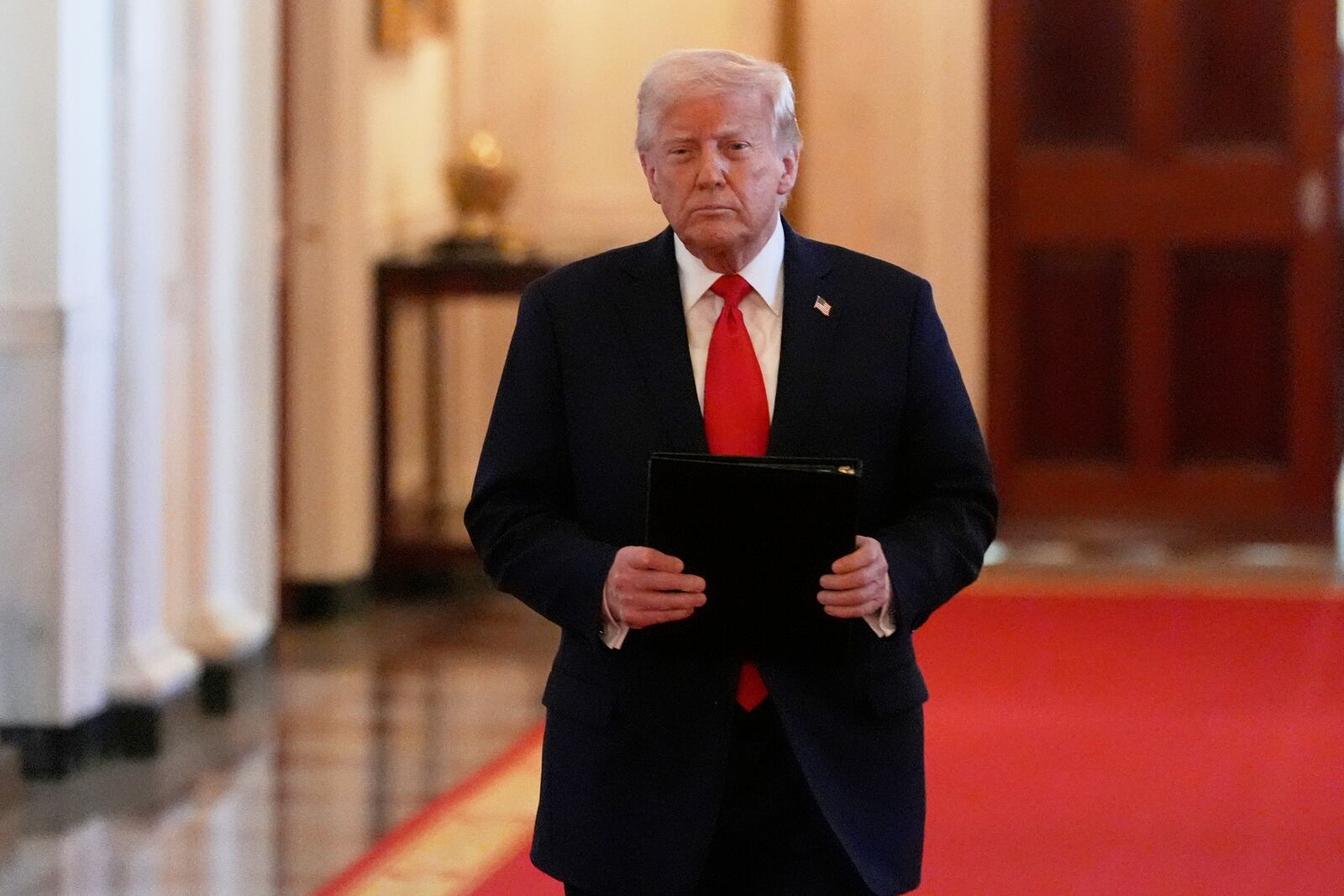 President Donald Trump arrives to speak at the Commander-in-Chief trophy presentation to the Navy Midshipman football team in the East Room of the White House, Tuesday, April 15, 2025, in Washington. (AP Photo/Alex Brandon)