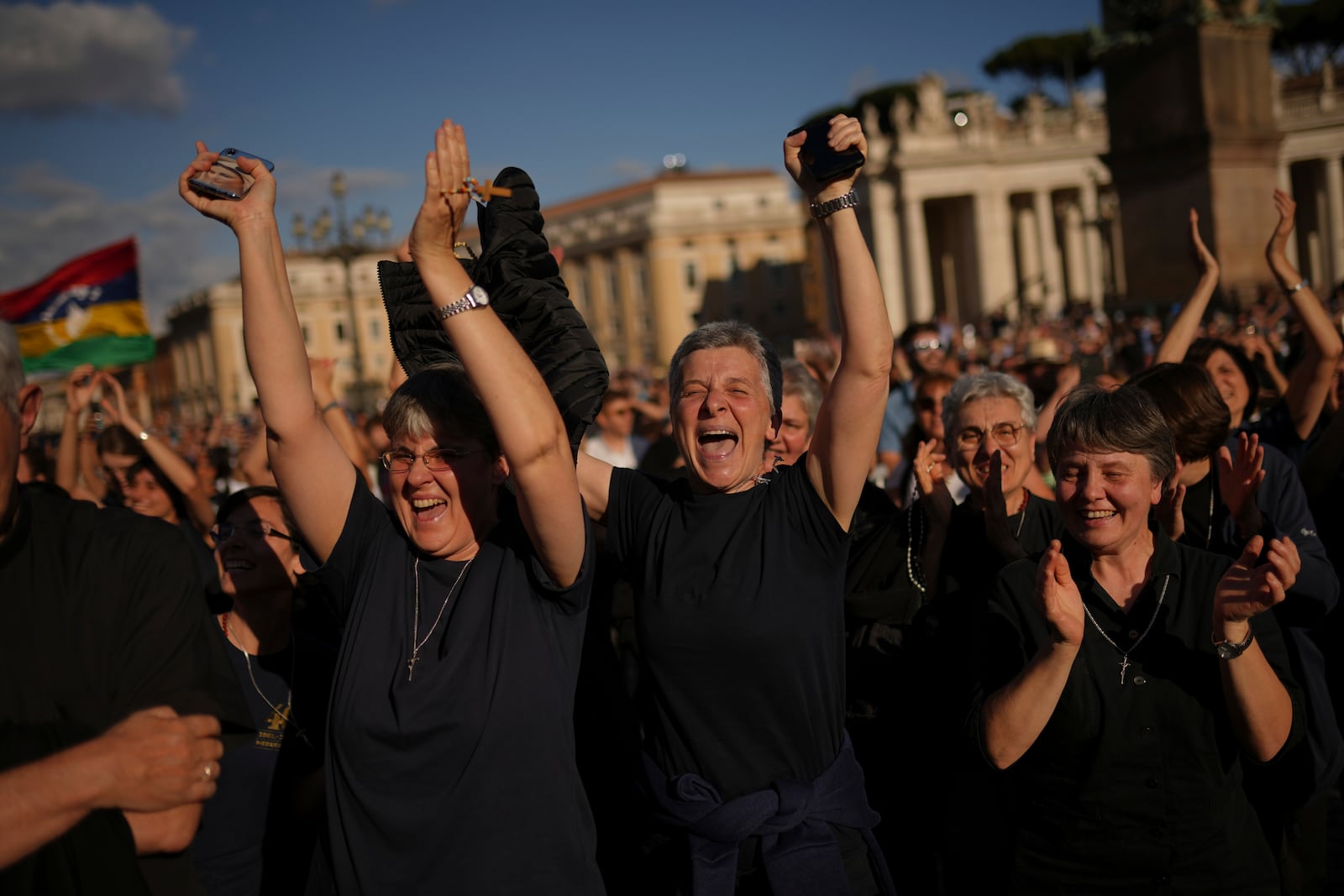 Faithful react after the announcement of the newly elected Pope Leo XIV at the Vatican, Thursday, May 8, 2025. (AP Photo/Francisco Seco)