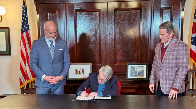 Rep. Bernie Willis, R-Springfield, watches alongside Ohio Lt. Gov. Jon Husted as Ohio Gov. Mike DeWine signs House Bill 77, a Willis bill to regulate drone usage in Ohio. Jan. 8, 2024.