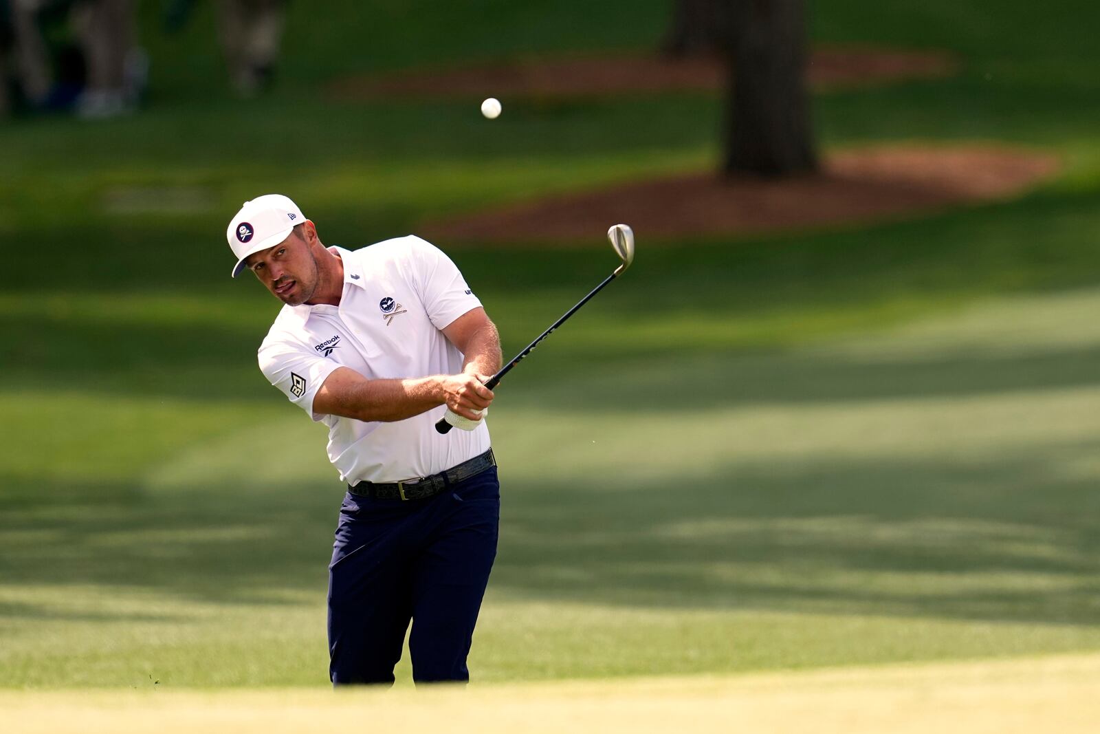 Bryson DeChambeau chips to the green on the seventh hole during the third round at the Masters golf tournament, Saturday, April 12, 2025, in Augusta, Ga. (AP Photo/David J. Phillip)